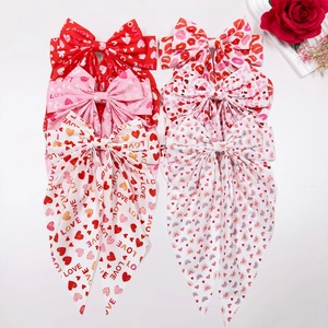 Red and pink oversized bow hair clips with heart and lip prints for Valentine gift