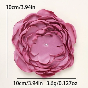 Detail view of 10cm handmade magenta fabric flower with multi-layer satin petals