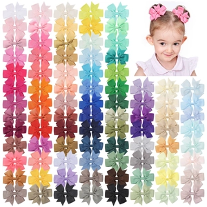 Detailed view of assorted grosgrain ribbon butterfly bow hair clips for kids in many colors