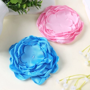 Detailed top view of 10cm handmade 9-layer fabric flowers in soft pink and bright blue colors