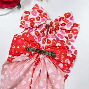 Oversized Valentine's Day bow hair clip with red love heart and lip prints on white fabric