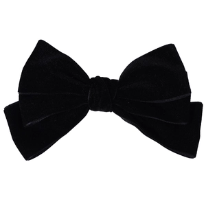 Detailed close-up showing the soft velvet texture and double-layered structure of the black bow hair clip