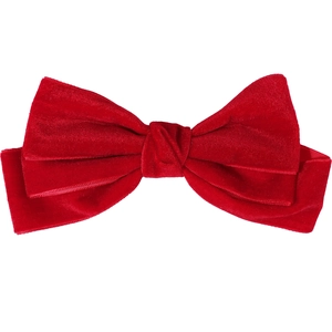 Close-up of a large red velvet triple-layered bow hair clip with luxury fabric texture