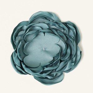 Detailed top view of a 10cm teal fabric flower with 9 layers and heat-treated edges