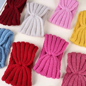 Close-up of colorful knitted cross headbands in various vibrant colors for kids and babies