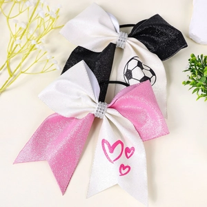 Detail of glittery bow hair ties with football and heart patterns and sparkling rhinestones