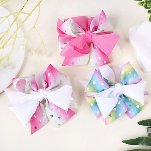 Detail showing three gradient heart print bows made of high quality grosgrain ribbon