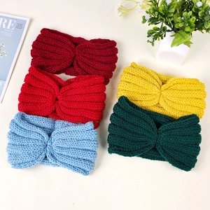 Flat lay of five chunky knit twist headbands in assorted colors for winter warmth