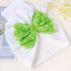 Dettaglio del turbante neonato con grande fiocco verde di rose in tulle 3D