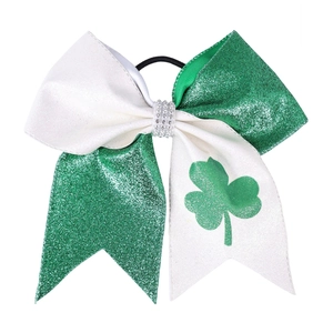 Detail of St. Patrick's Day glitter hair bow with shamrock print and rhinestone center