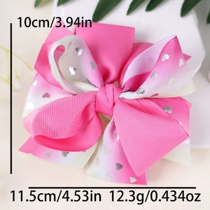 Detail of a large pink gradient ribbon hair bow with glitter hearts and size measurements