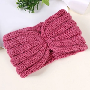 Detailed knit texture of a rose pink winter headband with a stylish twist design