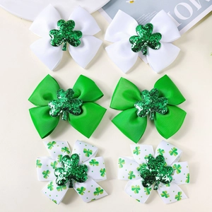 Detail of St. Patrick's Day hair clips with green shamrocks and ribbon bows for girls