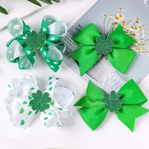 Set of four St. Patrick's Day hair bows with green shamrocks and glitter accents