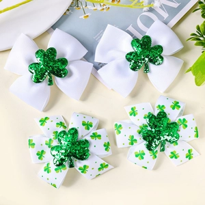 Detail of St. Patrick's Day hair clips with green shamrock patterns and glittery bows