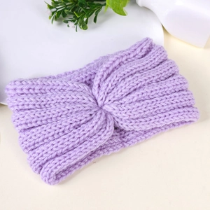 Close-up of lilac knitted twist headband with textured wool material for winter