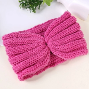 Close-up of rose red knitted headband showing thick yarn texture and cross knot detail