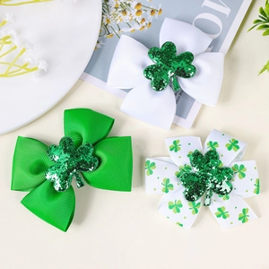 Detail view of St. Patrick's Day hair bows with green sequin shamrocks and clover prints