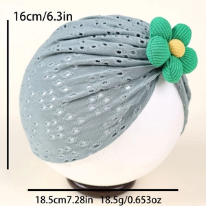 Detailed size view of grey-blue hollow-knit baby turban with green and yellow flower