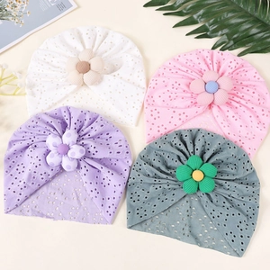 Detailed macro view of breathable hollow knit fabric with 3D floral accents on baby turbans