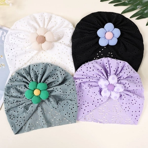 Detailed view of breathable hollow knit baby turban hats with 3D floral accents