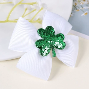 Detail view of St. Patrick's Day white grosgrain bow hair clip with green sequin shamrock