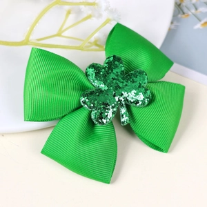 Close-up of green grosgrain ribbon bow with sequin shamrock for St. Patrick's Day hair clips