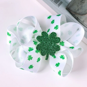 Close-up of white clover bow clip with a large green sequin shamrock for St. Patrick's Day