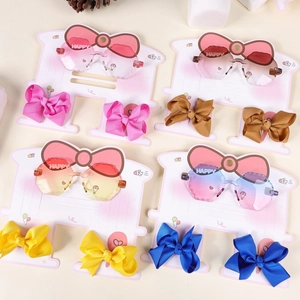 Macro view of gradient polygon sunglasses with matching bow clips in four colors