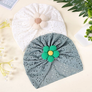 Detailed view of hollow eyelet texture and corduroy fabric flower on baby turban hats
