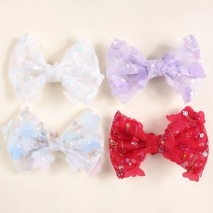 Detailed macro view of colorful sequin bow hair clips with delicate floral and butterfly patches