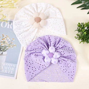 Detail of breathable hollow lace baby turban hats with decorative 3D floral accents