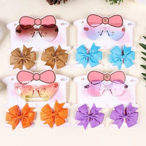Detailed set of gradient heart sunglasses and matching bow hair clips in four colors
