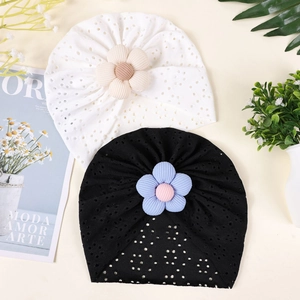 Close-up of breathable cotton infant turban hats with delicate hollow-out floral details