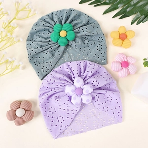 Detailed view of hollow knit cotton baby turban caps with 3D floral decorations
