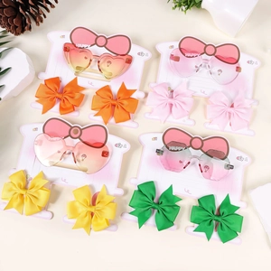 Set of four colorful gradient heart sunglasses with matching ribbon bow hair clips for kids
