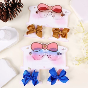 Close-up of kids heart sunglasses with bow hair clips on decorative gift display