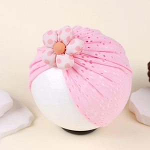 Detail of pink breathable mesh baby turban with a red polka dot flower ornament