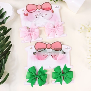 Kids heart sunglasses and bow hair clips set featuring gradient pink lenses and rib ribbons