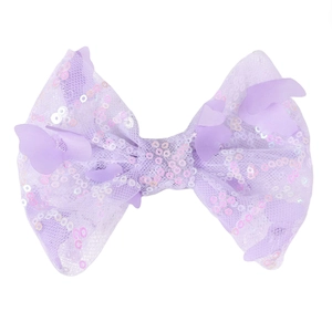 Detailed view of purple sequined bow hair clip with 3D butterfly appliqué on white surface