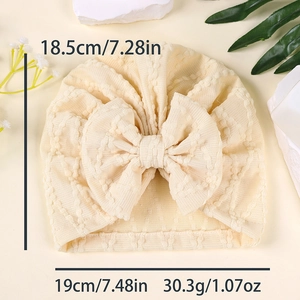 Bonnet turban pour nouveau-né avec grand nœud et texture à pois en couleur crème