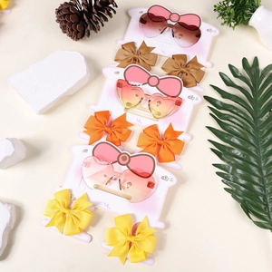 Detailed set showing kids gradient heart sunglasses and matching grosgrain bow hair clips