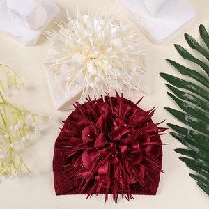 Detail von Baby-Stirnbändern mit übergroßen Strass-Kamelienblüten in zwei Farben