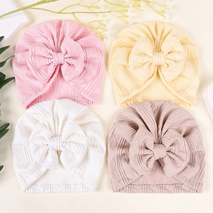 Soft newborn infant turban hat set with large bows in pink and cream colors