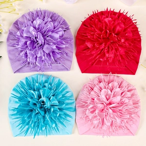 Detailed grid of baby hats in purple, red, blue and pink with large 3D flowers
