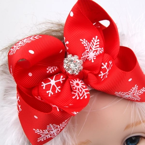 Close-up of a Christmas bow headband with snowflake patterns and sparkling rhinestone