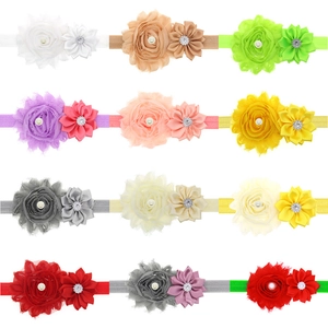 Detail of 12 colorful baby headbands with chiffon flowers and pearl accents