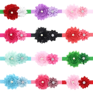 Set of 12 colorful floral baby headbands with pearls and rhinestones on white background