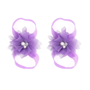 Purple chiffon flower barefoot sandals for babies with pearls and rhinestones on white background