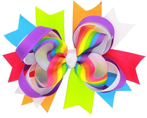Close-up of rainbow layered grosgrain ribbon bow hair clip for girls with fine texture